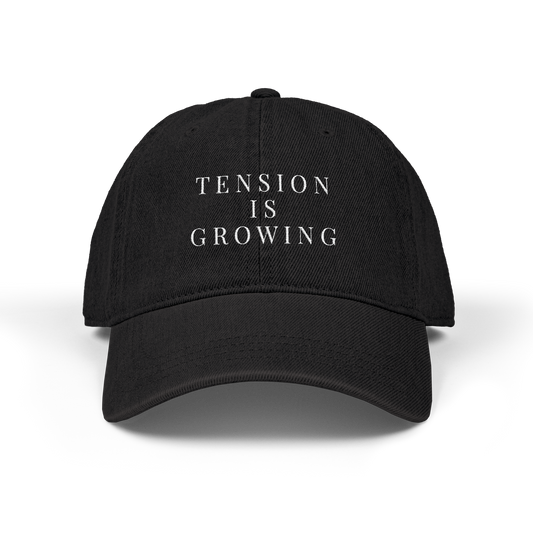 Tension hat featuring the “Tension Is Growing” text design associated with Alon Mor.